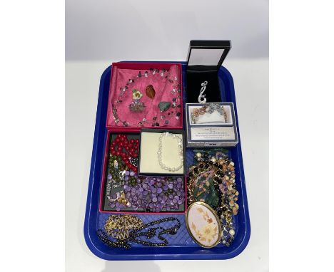 A tray of assorted costume jewellery, necklaces and butterfly bangle