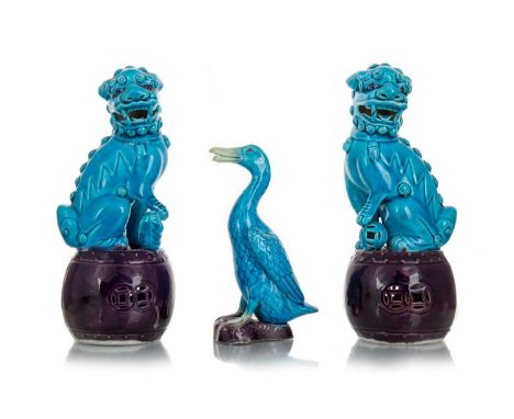 PAIR OF CHINESE TURQUOISE FOO DOGS AND A CHINESE TURQUOISE FIGURE OF A DUCK each Foo Dog on raised purple drum shaped bases, 