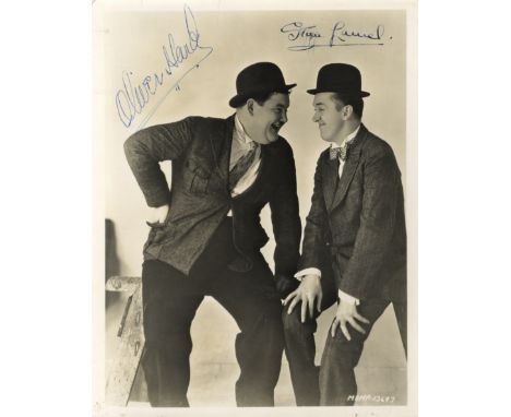 LAUREL STAN: (1890-1965) English Film Comedian. Vintage signed sepia 8 x 10 photograph, the image depicting Laurel seated in 