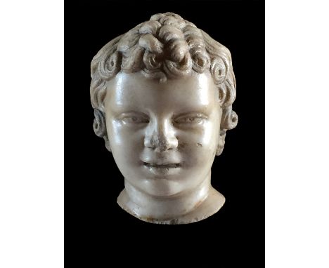 A Roman marble head of a youth 3rd century AD; 14 cm (5,33 in) high; Possibly from a figure of Eros depicting as a child, lux