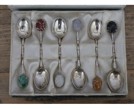 A cased set of Chinese silver teaspoons with multi-coloured jade finials, marked 'MADE IN HK 90%SILVER KH Q'.  