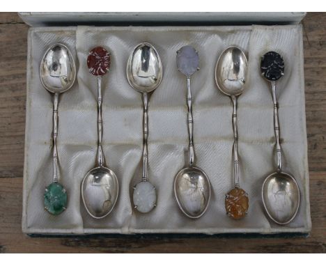 A cased set of Chinese silver teaspoons with multi-coloured jade finials, marked 'MADE IN HK 90%SILVER KH Q'.  