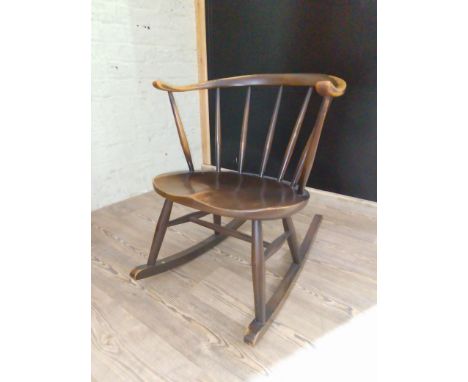 An Ercol Cow Horn rocking chair. Condition- generally sturdy, some wear to the finish on the arms, some surface marks and scr