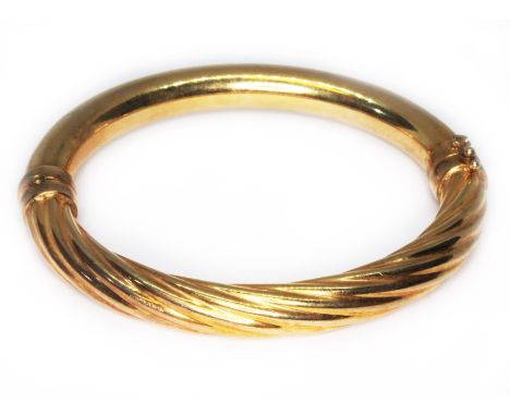 An Italian twist bangle, marked '375', diam. 5.5mm, wt. 16.6g.  