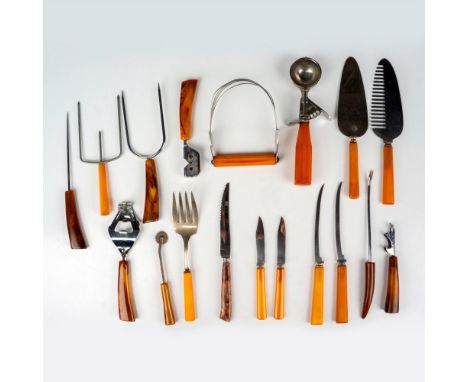 A nostalgic vintage kitchen utensil grouping featuring a variety of essential tools, including a Shore Craft levered ice crea