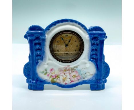 Glossy porcelain clock decorated with flowers. Stamped 8770 on bottom. Dimensions: 6.5"L x 1.5"W x 5.25"HManufacturer: New Ha