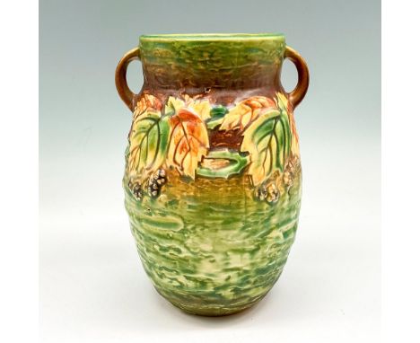 Light glaze over green base and raised floral design colored in orange and brown with brown banding at top. Issued: 20th cent