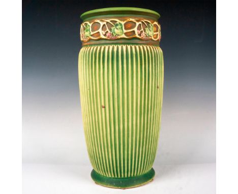 Wide mouthed floor vase with light glaze over sage green with a banded design of grapes on a vine at top of vase. Vase is acc