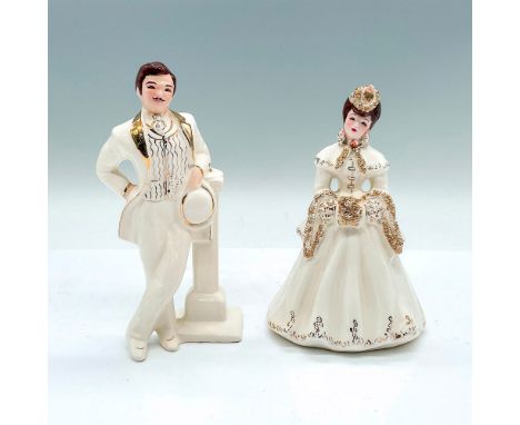 A glossy figure of a man and a woman in a white suit and dress with gilded accents. Florence Ceramic backstamps. Jim: 3"L x 2