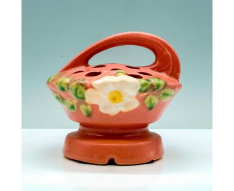 A light pink flower display with a handle and is decorated with a low relief image of a white flower among some foliage. Rose