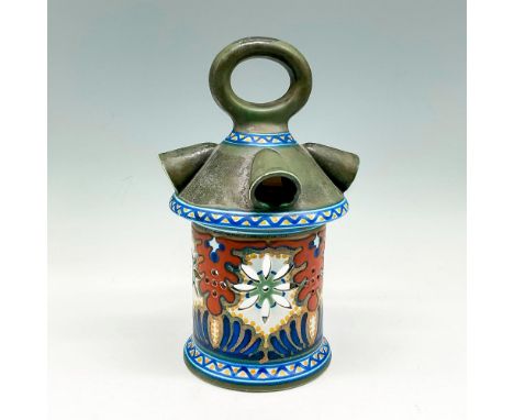Beautifully decorated light holder has a base color in muted green, with cutouts accentuated by colorful design in rust, blue