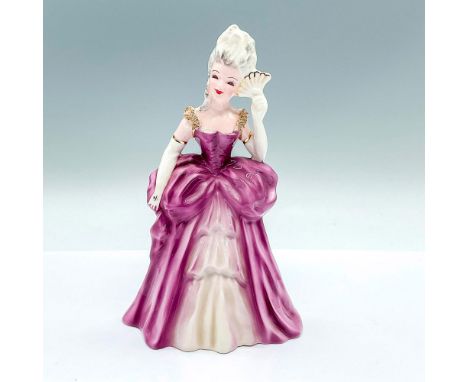 A beautiful figure of a woman dressed in a lilac gown with white and gilded accents. Florence Ceramic backstamp. Dimensions: 