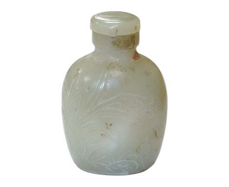 A Chinese carved jade snuff bottle with stopper, 7cm high including stopper. Condition - good