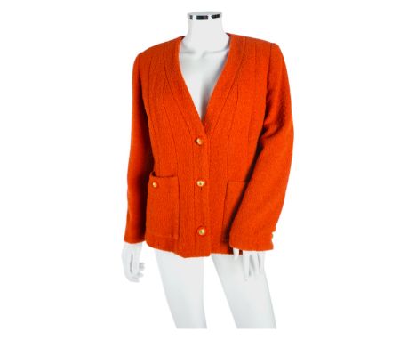 A Chanel lady's orange jacket, EU 44 Jacket’s left pocket missing button; some light wear to pile.  Age guessing 2000.