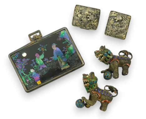A Chinese silver buckle with filligree butterfly decoration, a pair of enamelled miniature lion dogs with balls and a small l