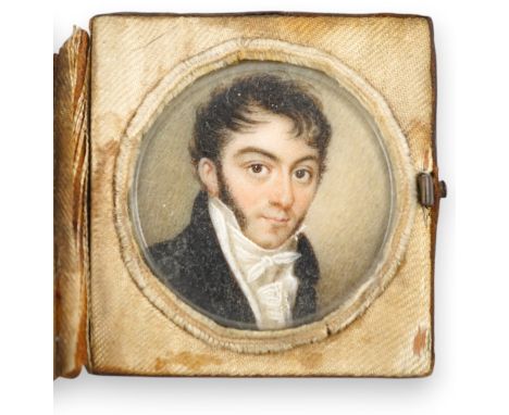 A mid 19th century French portrait miniature of a gentleman on ivory, in leather case inscribed 'Souvenir', 4.3cm high overal