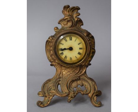 A French Gilt Metal Mantel Clock with Moulded and Pierced Decoration, 16cms High 