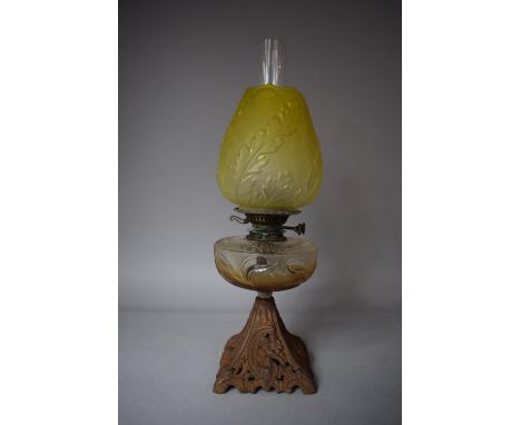 A Victorian Iron Based Oil Lamp with Yellow Glass Shade and Glass Reservoir 