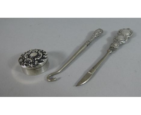 A Small Circular Silver Pill Box and Two Silver Handled Manicure Tools 