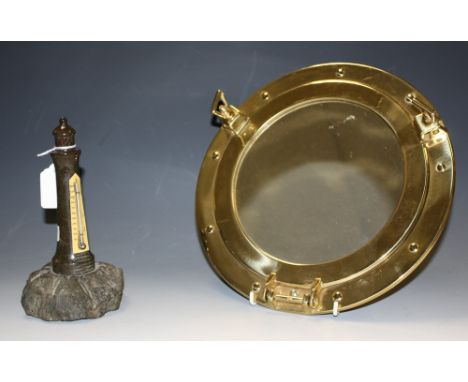Marine Interest - a carved serpentine stone desk thermometer, as a lighthouse, 20.5cm high; a port hole wall mirror (2)