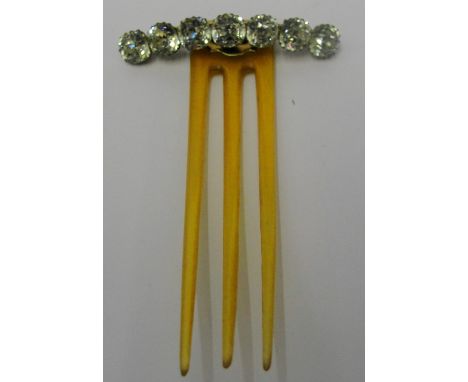 An Art Nouveau Hair Comb, c1900:
a three-pronged hair comb with hinged top set with seven cushion-cut paste stones
L 9cm x W 