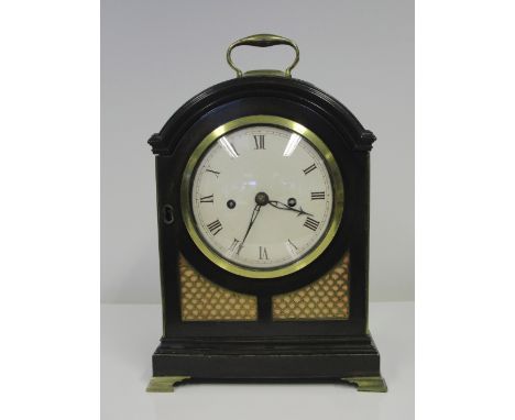 A 19th Century Mahogany Bracket Clock by Mitchell & Russell, Glasgow:
The circular enamel dial with Roman numerals, eight-day