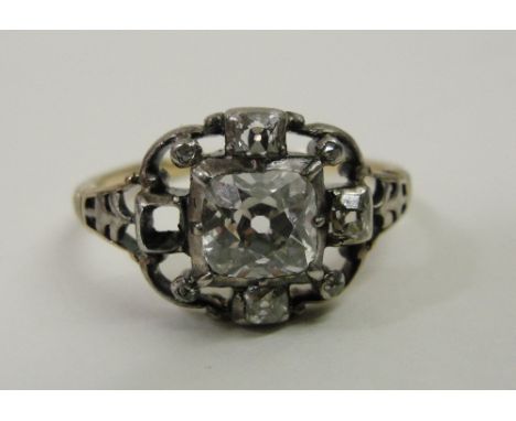 An Art Deco diamond dress ring 
set with central cushion cut diamond and surrounding smaller stones in unhallmarked gold shan