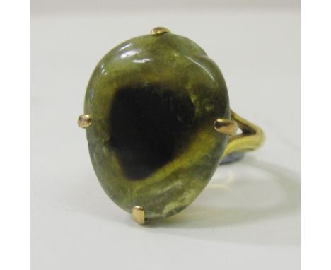 A Chinese gold ring with hardstone drilled button