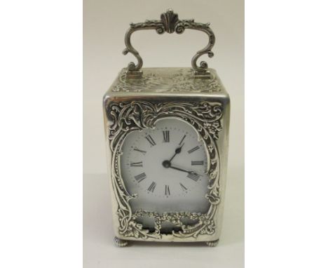 An Art Nouveau Silver Carriage Clock:
Silver hall marked clock London C1898 by W C ,full silver case with neo classical scene