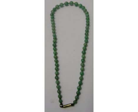 A 1920s Graduated Jade Bead Necklace:
on a barrel 9ct clasp, well strung and knotted in green cotton with 57 beads in pale gr