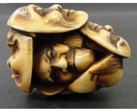 A Japanese Ivory Netsuke:
19th century
carved as a group of six theatrical masks
H 4.5 cm
 CONDITION REPORT: Perfect conditio