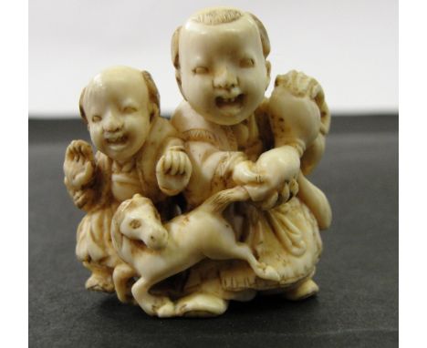 A Japanese Ivory Netsuke:
Meiji period
In the shape of two boys playing with a gourd and miniature horse.
H 3.5 cm 
 CONDITIO