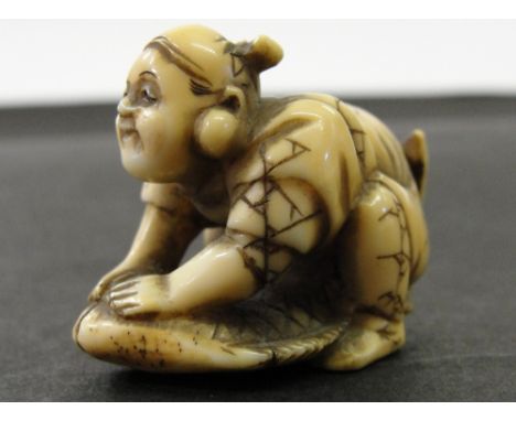 A Japanese Ivory Netsuke:
19th century
In the shape of Kintaro kneeling on a carp. Signed Bunshu to the base
W 4 cm 
 CONDITI