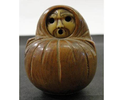 A Japanese Wood Netsuke:
Edo period
In the shape of Daruma. The face carved in ivory
H 5 cm