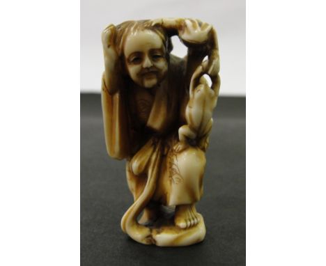 A Japanese Ivory Netsuke:
Edo period
In the shape of Gama Sennin with two frogs. With the inscription 'Sennin' to the base
H 