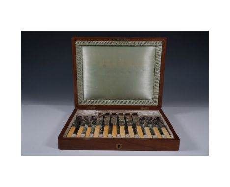Antique A&amp;DS Britannia Plate cutlery set featuring ornately decorated knives and forks with carved handles, presented in 