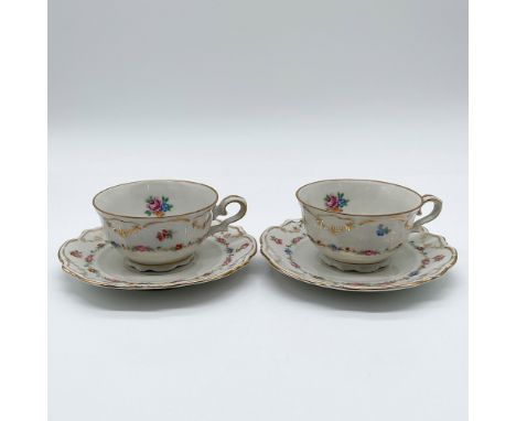 Pair of Bareuther Bavaria porcelain teacups and saucers with colorful floral patterns and gold accents. The backstamp indicat
