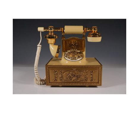Vintage Western Electric rotary telephone featuring an ornate cream and gold design. The telephone showcases intricate relief