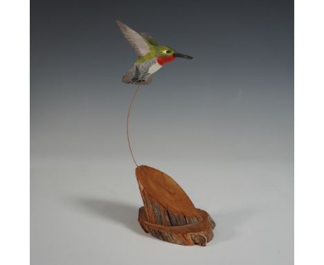 A finely hand-carved wooden hummingbird sculpture by RUCH, a family known for collaborating with local carvers on Vancouver I