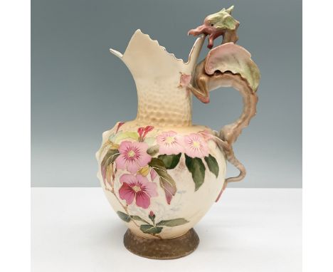 A vintage hand-painted china pitcher featuring a distinctive dragon handle design. The body is adorned with delicate floral m