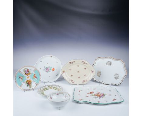 A collection of seven porcelain serving trays and dishes featuring various floral patterns, gold accents, and decorative bord