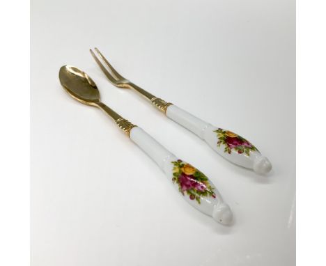 Elegant 6-inch stainless steel spoon and fork set with gold-tone accents. Each piece features a smooth, tapered handle adorne