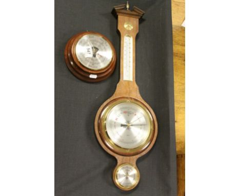 Two vintage wall hanging barometers to include a Daymaster and a larger German example.