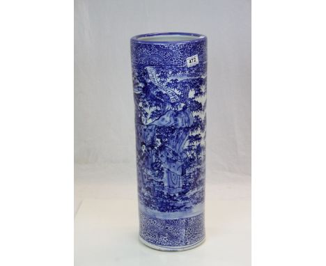 Blue and white oriental stick stand with figures in a garden setting 