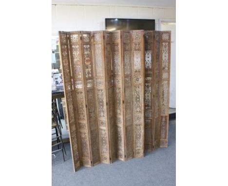 Indian Hardwood Pierced and Profusley Carved Twelve Panel Folding Screen, each panel 184cms x 15cms