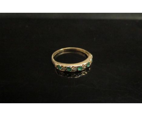 A 9ct gold emerald and diamond half hoop. Size M, 1.3g 