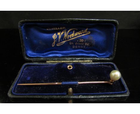 A gold stick pin with removable single pearl on screw fitting with an 18ct gold stud fitting, in fitted box 