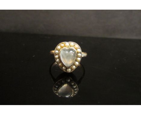 A heart shaped moonstone and seed pearl ring, unmarked shank. Size N, 3.7g 