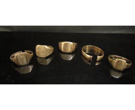 Three 9ct gold signet rings (cut) a 9ct gold signet ring monogrammed K set with a small diamond and a 9ct gold band (cut) (5)