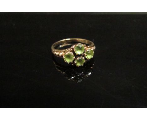 A 9ct gold four stone set peridot ring. Size M/M, 2.5g 